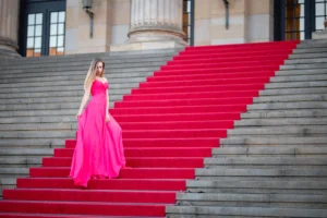 female-model-wearing-pink-evening-gown-while-standing-steps